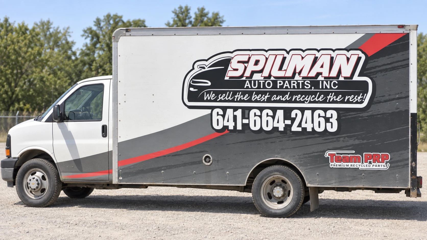 Spilman Auto Parts box truck with the yard's phone number, (641) 664-2463